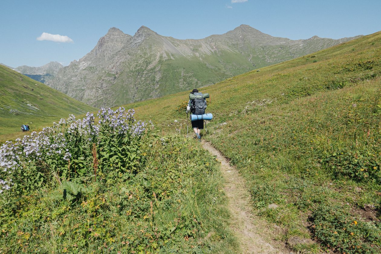 Hiker carrying a backpack on a trail