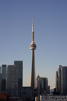 Stunning view of Toronto skyline featuring the iconic CN Tower against a clear blue sky.