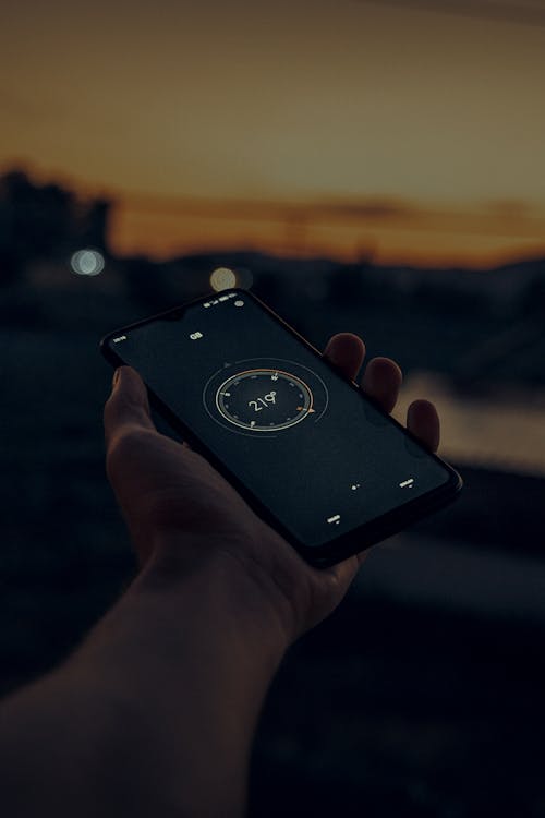 Close-Up Shot of a Person Using a Compass in His Smartphone