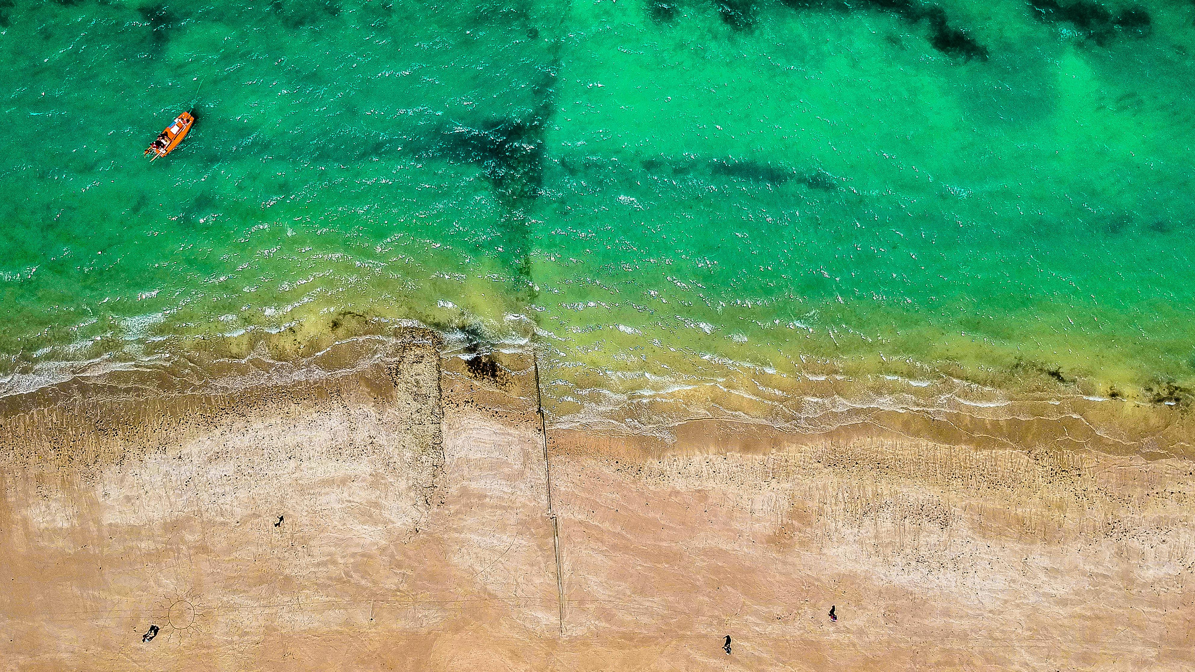 brown boat on body of water