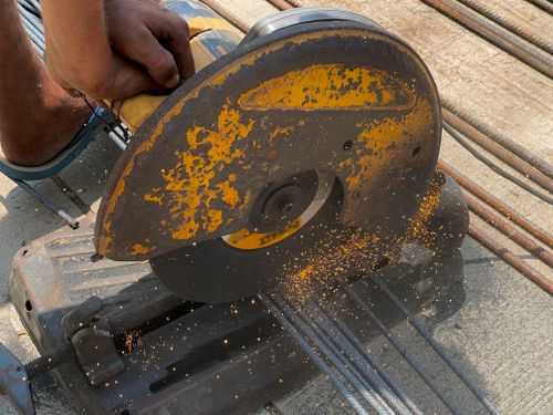 Free A detailed view of an angle grinder cutting metal rods outdoors in Rasulpur, India. Stock Photo