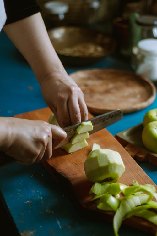 Person Slicing Green Apples 