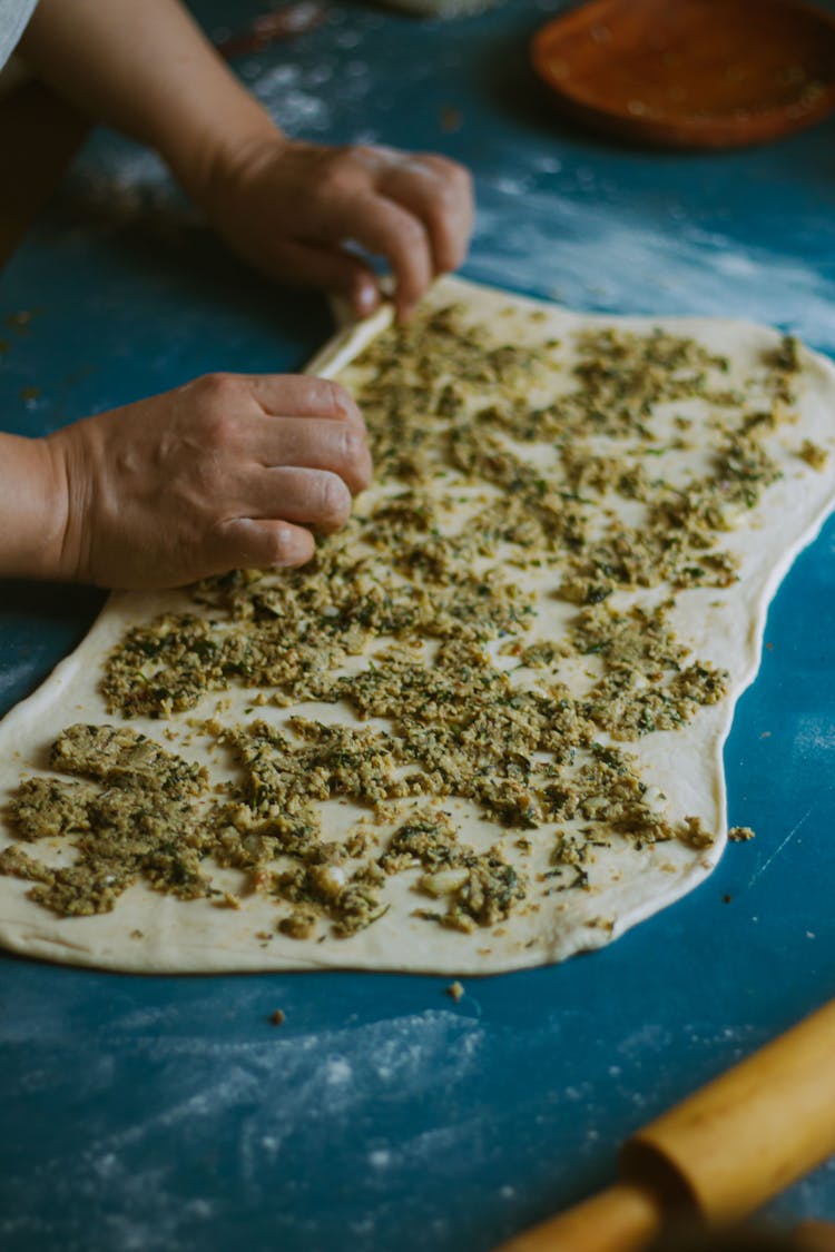 Woman Preparing Food Using Dough And Stuffing