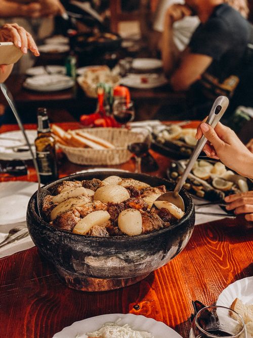 Free Gourmet meal shared among friends in a rustic restaurant setting. A blend of flavors and good company. Stock Photo