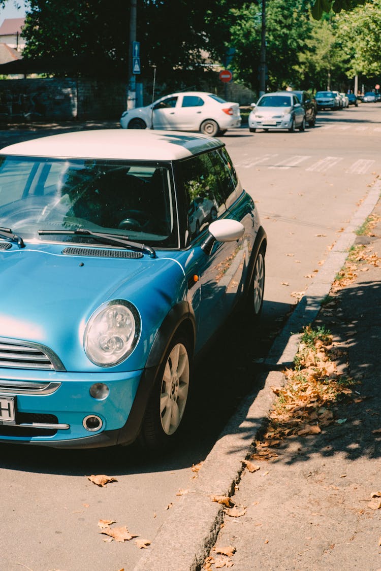 A Blue Mini Cooper Parked On The Street