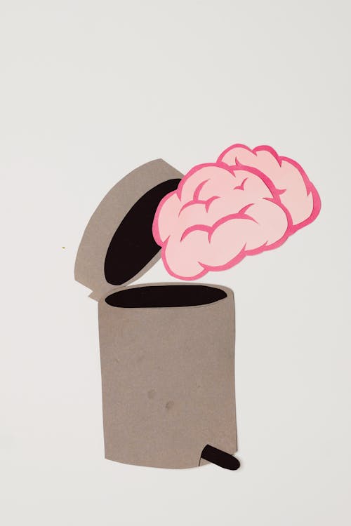Free Artistic Concept of Throwing a Brain in a Trash Can Stock Photo