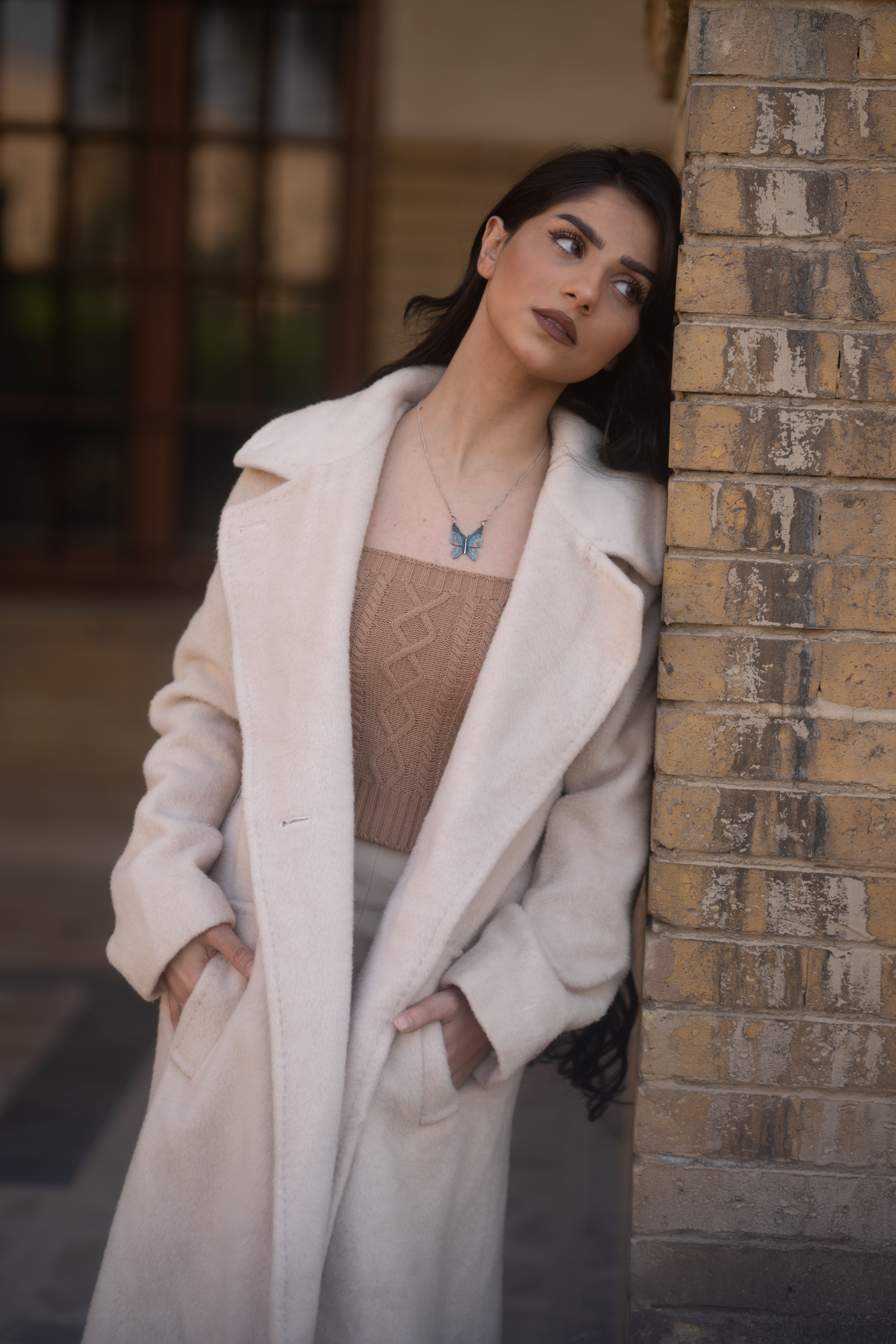Woman in Brown Coat Standing Near Glass Wall · Free Stock Photo