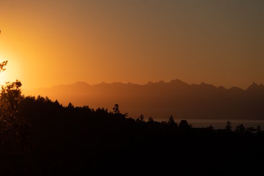 Silhouetted mountain range during a vibrant sunset in Nanaimo, BC.