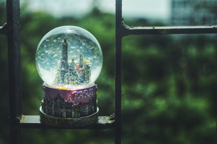 Paris Snow Globe Standing On A Metal Bar