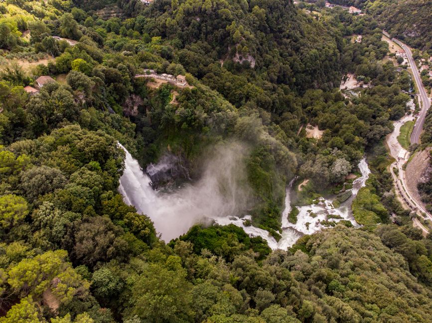 Ultimate Helicopter Scenic Flight over Victoria Falls 12-13 Minutes Flight Review Review 2026 - Stunning aerial view of a waterfall cascading into lush green forest, creating misty clouds.