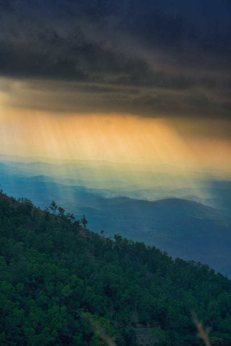 Rays Through The Clouds On Hills