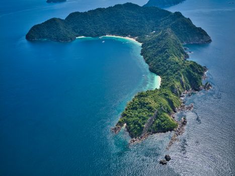 Explore the pristine beauty of a tropical island in Myanmar with crystal clear waters and lush greenery.
