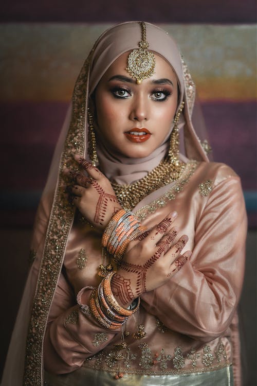 Free Woman in Beige Hijab and Decorated Dress with Mehendi on Hands Stock Photo