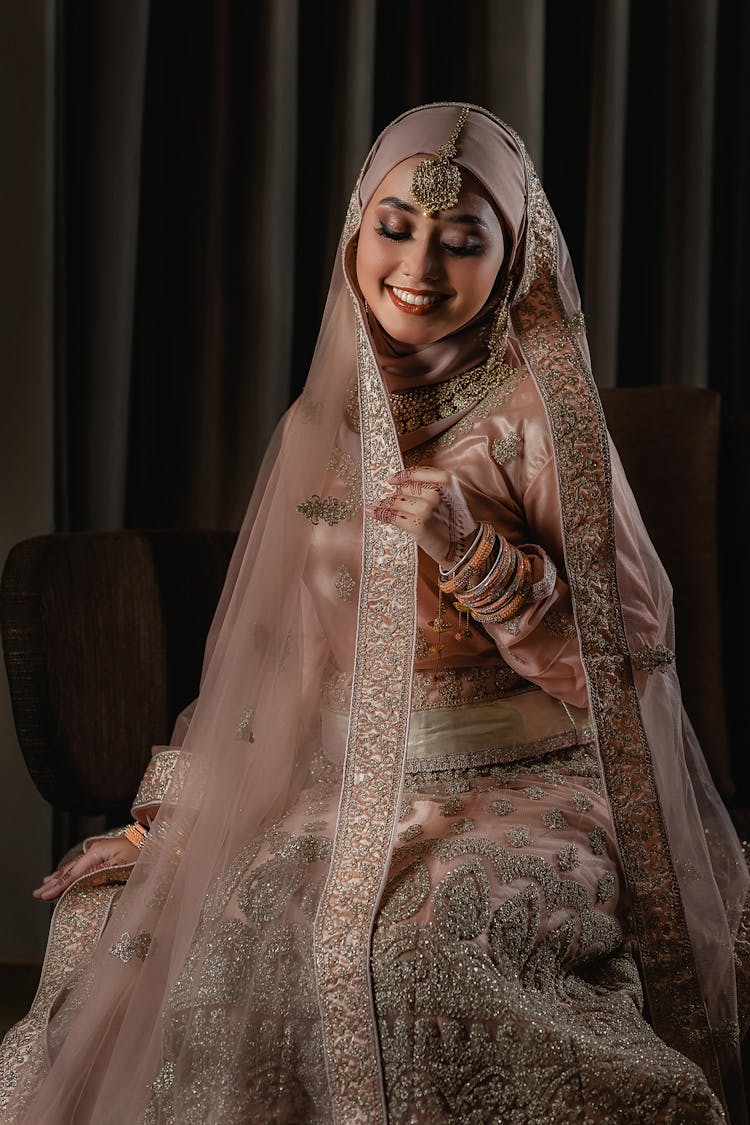 Smiling Woman In Beige Dress With Embroidery And Hijab