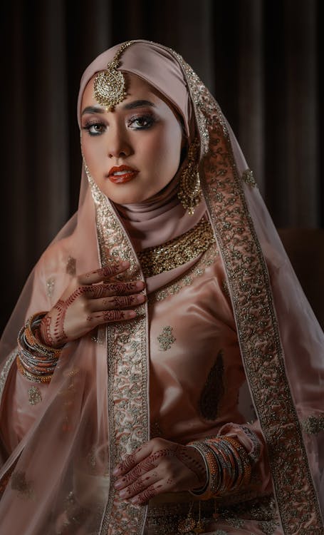 Woman in Beige Dress and Veil with Golden Accessories and Mehendi on ...