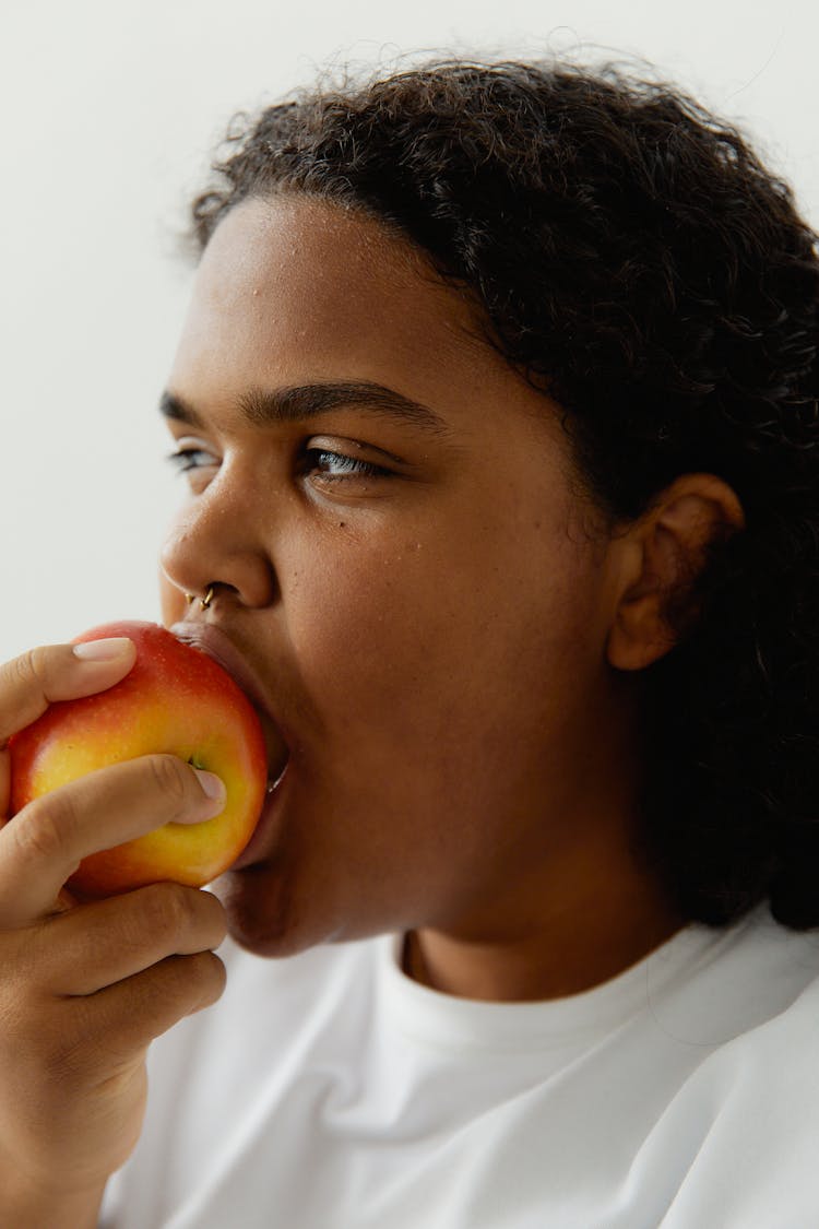 A Woman Eating An Apple