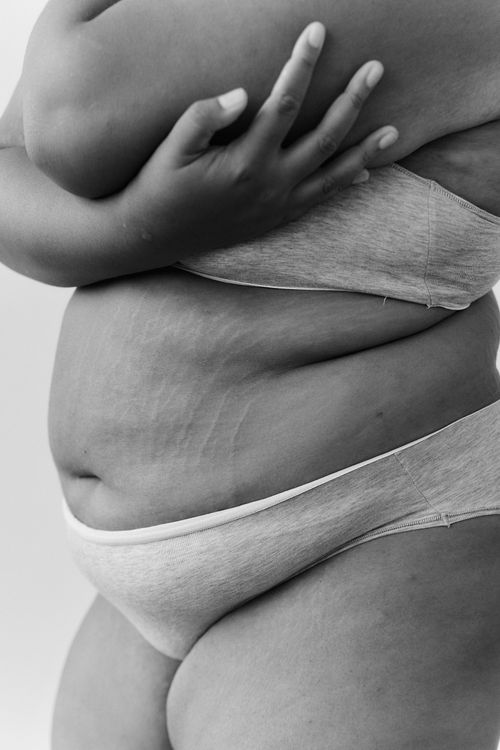 Free Embrace body positivity with this black-and-white close-up of a plus-size woman in lingerie. Stock Photo