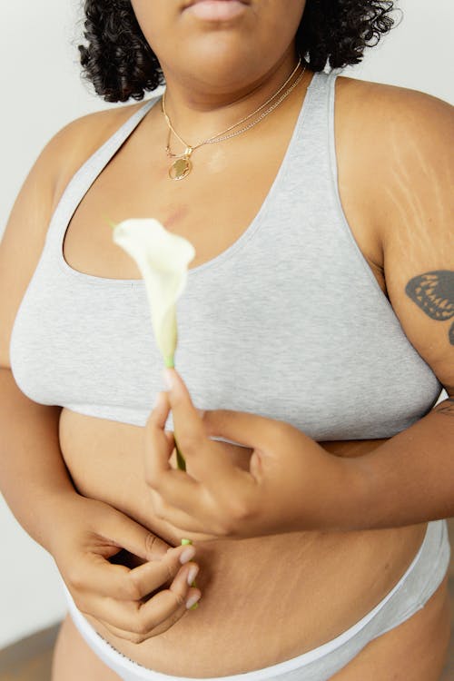 Close-Up Shot of a Woman Holding Her Underwear on White Background