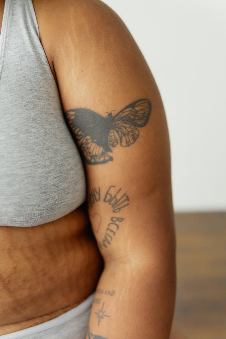 Close-Up Shot Of Tattoos On Person's Arm