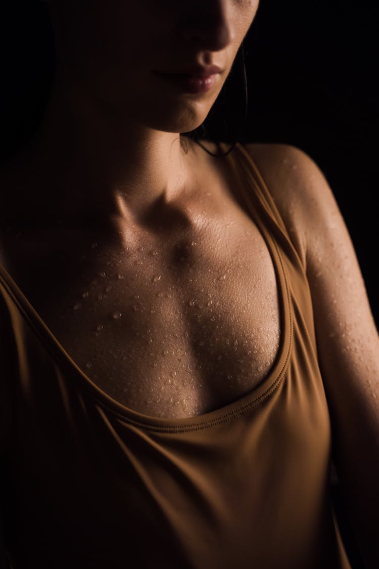 Woman In Brown Tank Top Sweating 