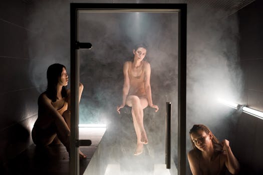 Three women enjoying a serene sauna experience amidst steam and soft lighting.