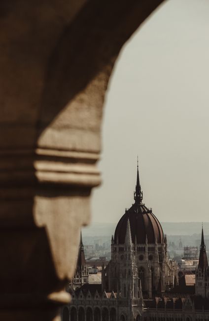 Captivating aerial view of the iconic Hungarian Parliament building in Budapest framed by architecture.