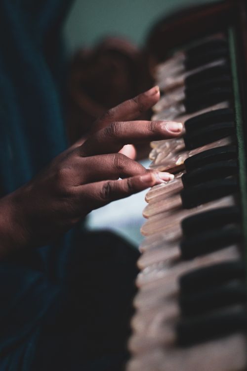 Free Intimate shot of a musician gracefully playing a piano, focusing on skilled hand movements. Stock Photo