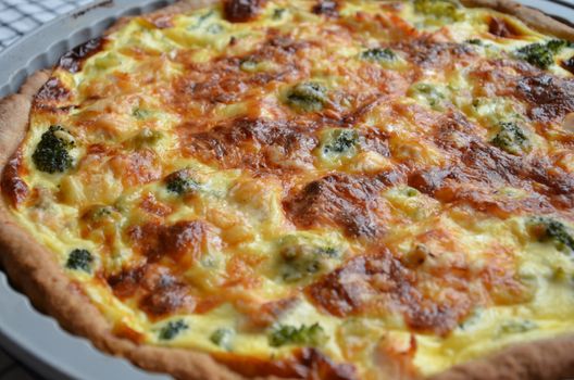 Delicious homemade quiche with cheese and broccoli, perfect for any meal or snack.