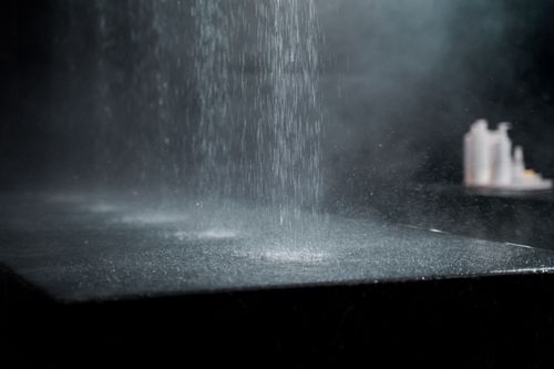 Free Artistic capture of water drops splashing on a dark surface, evoking a sense of calm and tranquility. Stock Photo
