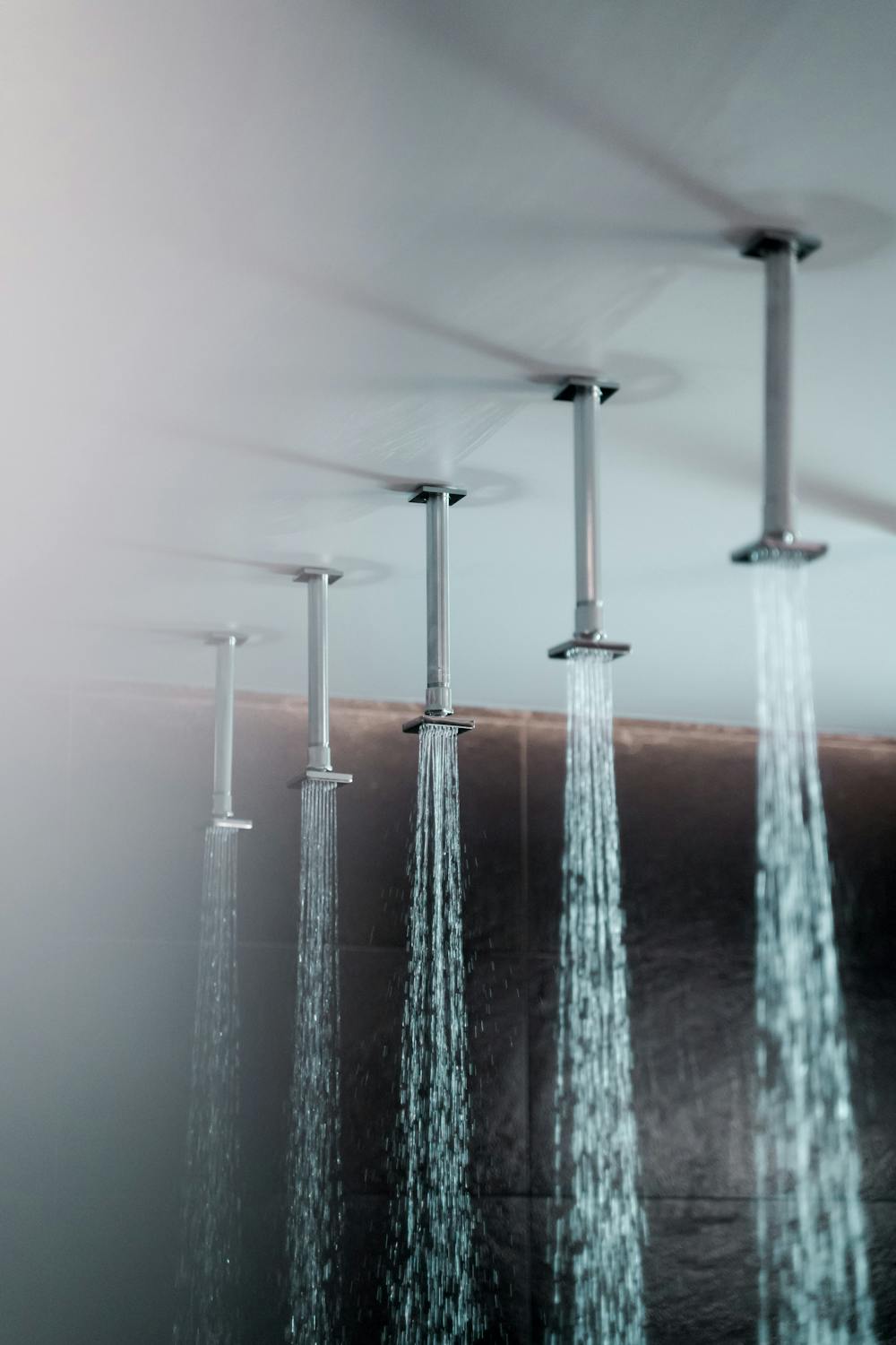 Water pouring from Shower Faucets on a Ceiling
