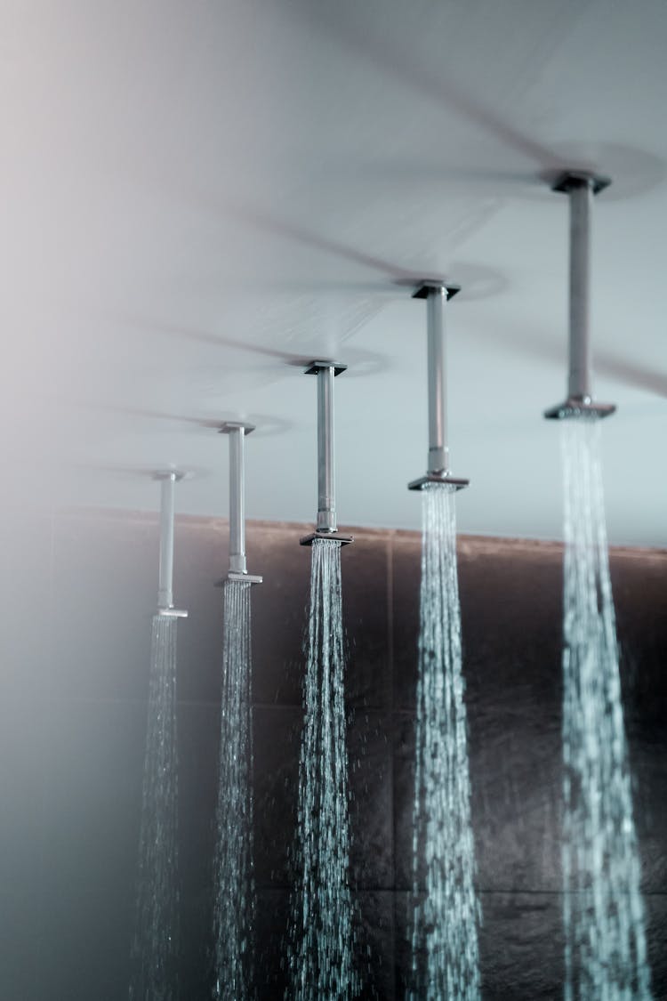 Water Pouring From Shower Faucets On A Ceiling 