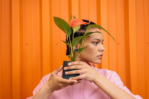 Portrait of Woman Holding Plant