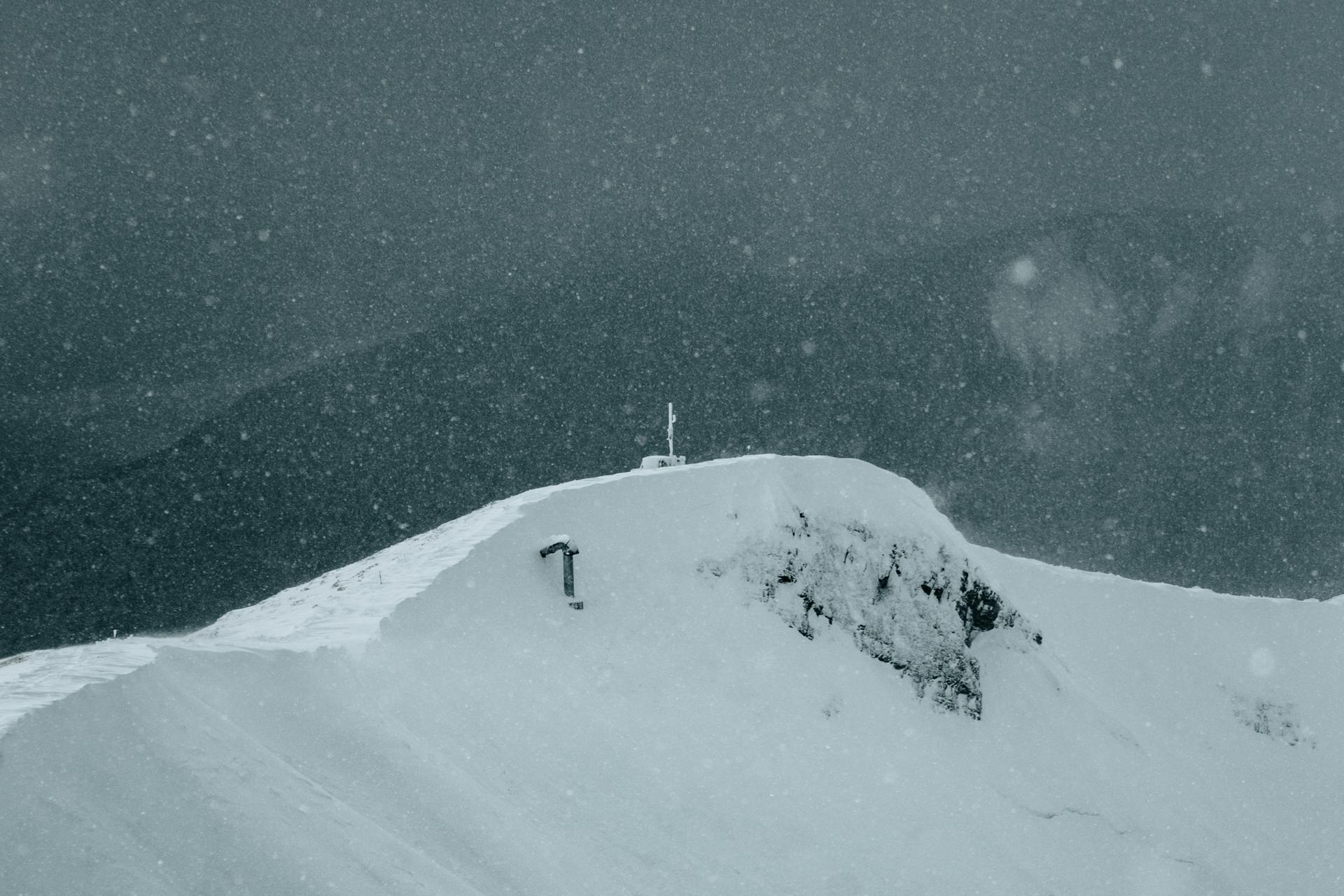 Capture of a snow-covered mountain peak during a snowstorm in Krasnaya Polyana, Russia.