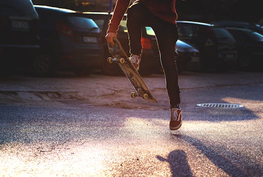 Person in Red Long Sleeved Shirt and Black Skinny Pants Riding a Skateboard