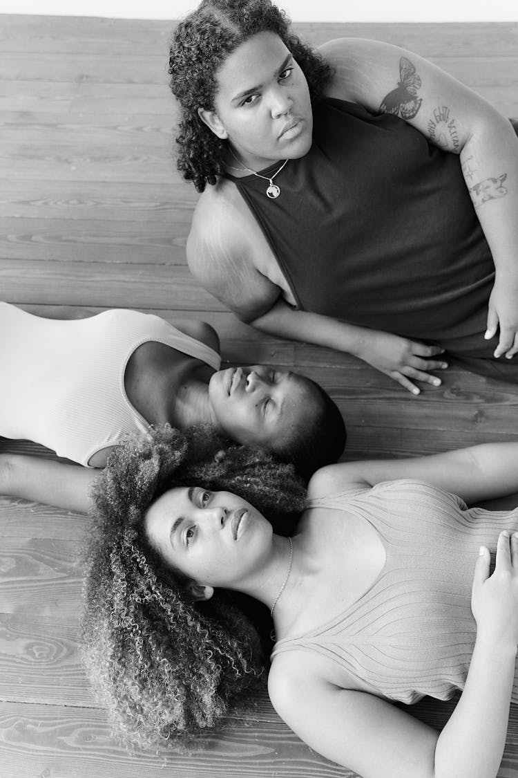 Girls Lying On Wooden Floor