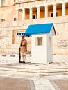 A Greek Presidential Guard Standing while Holding a Gun during the Day