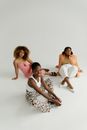 3 Women Lying on White Floor