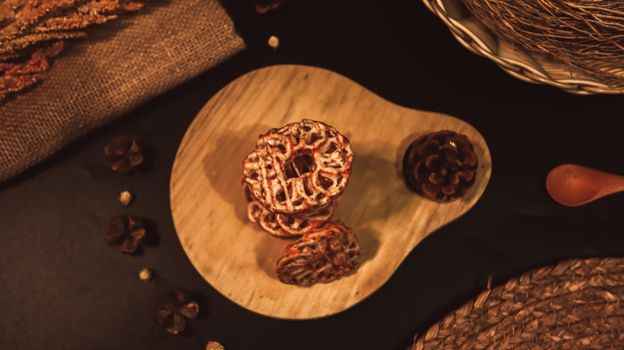 Homemade pastries on a wooden board with autumn decor in a warm, rustic setting. - Fotografer Sidoarjo