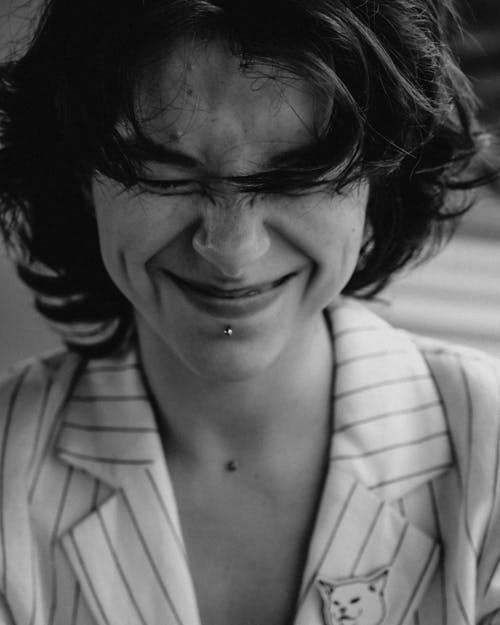 Grayscale Photo of a Pretty Woman Laughing