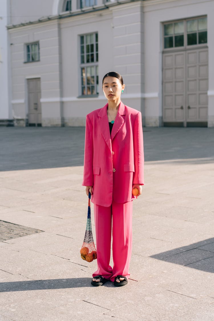 A Woman In Pink Suit And Pants