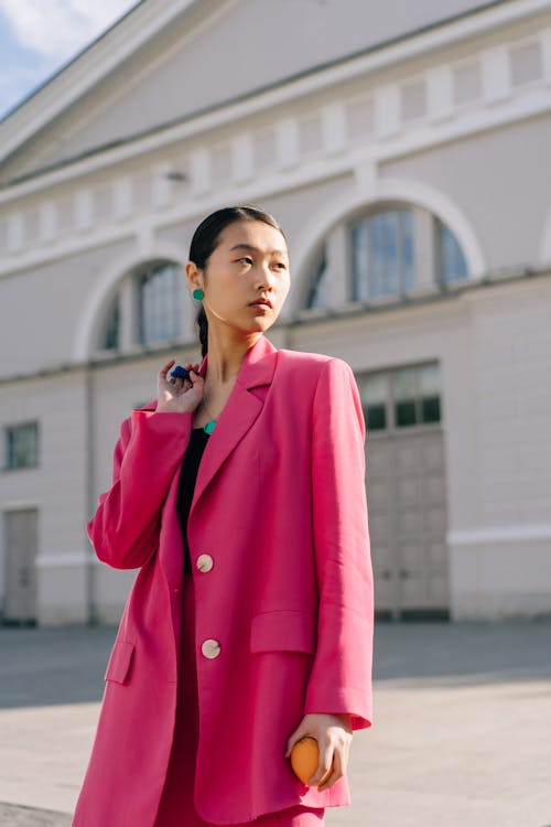 Woman in Pink Coat Posing Looking Afar 