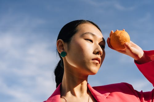 Free Close Up Photo of a Person Holding an Orange Stock Photo