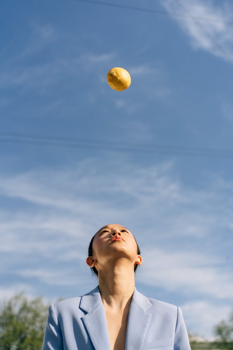 Lemon Floating Above Woman's Head