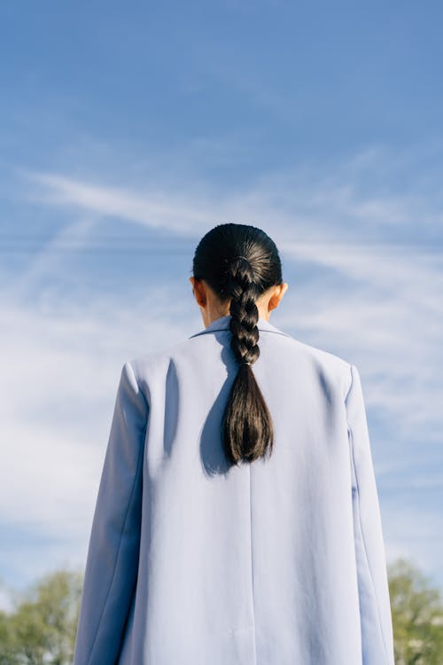 Back View of a Woman in Blue Coat With Braided Hair 