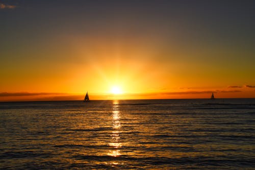 Sailboat on Sea During Sunset