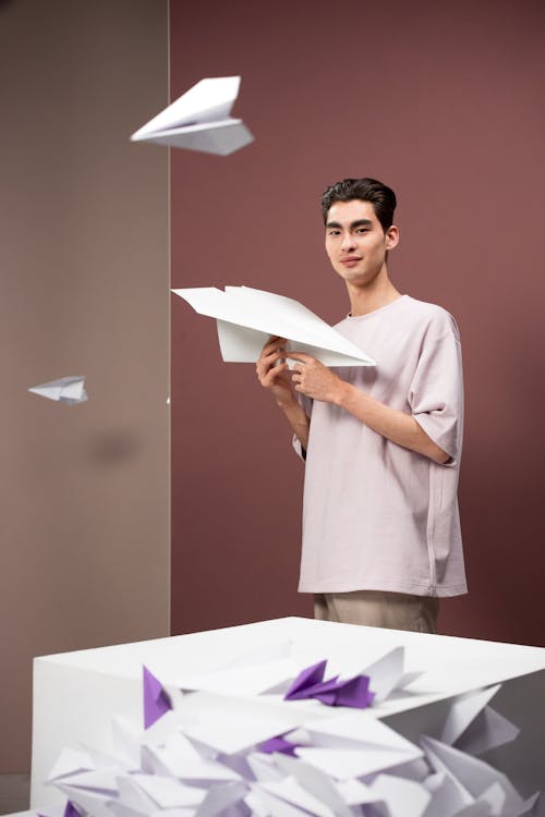 Free A Man Holding a Paper Airplane Stock Photo