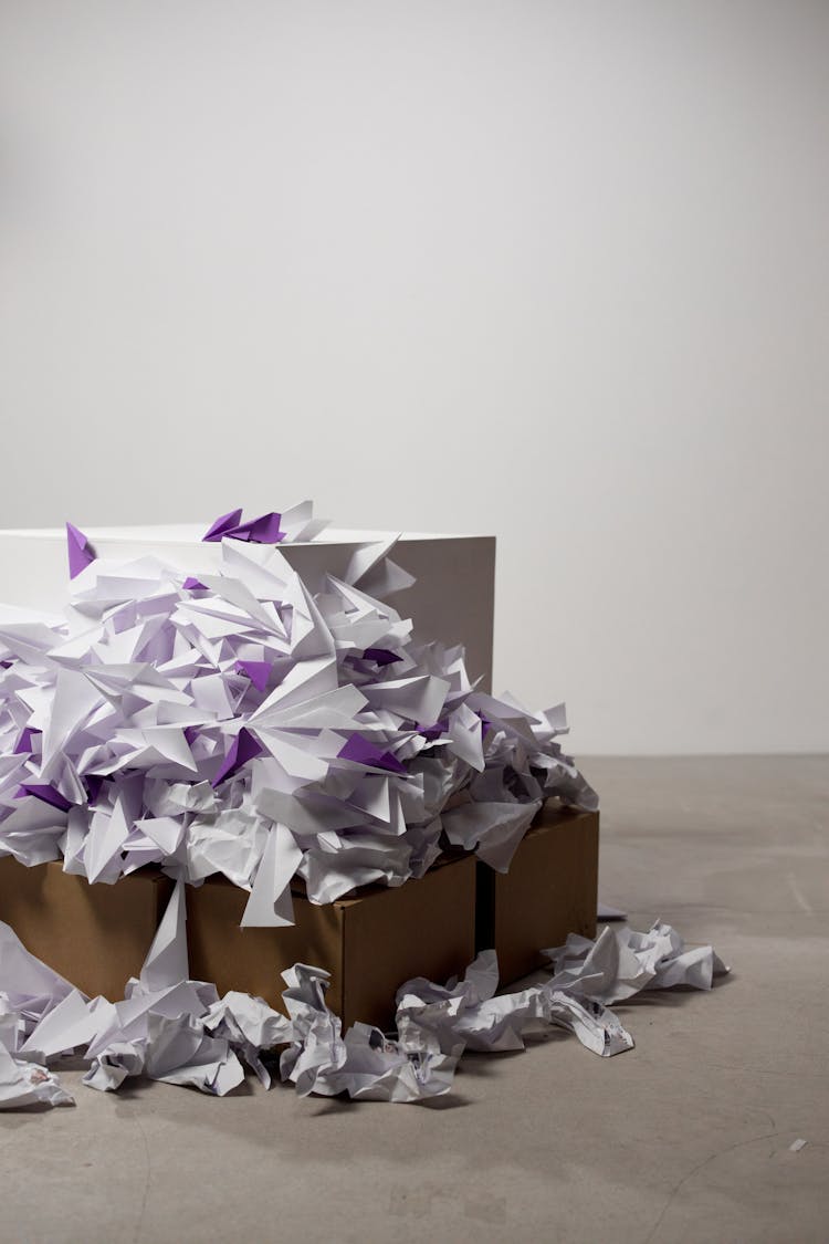 Purple And White Paper Trash On Brown Cardboard Box