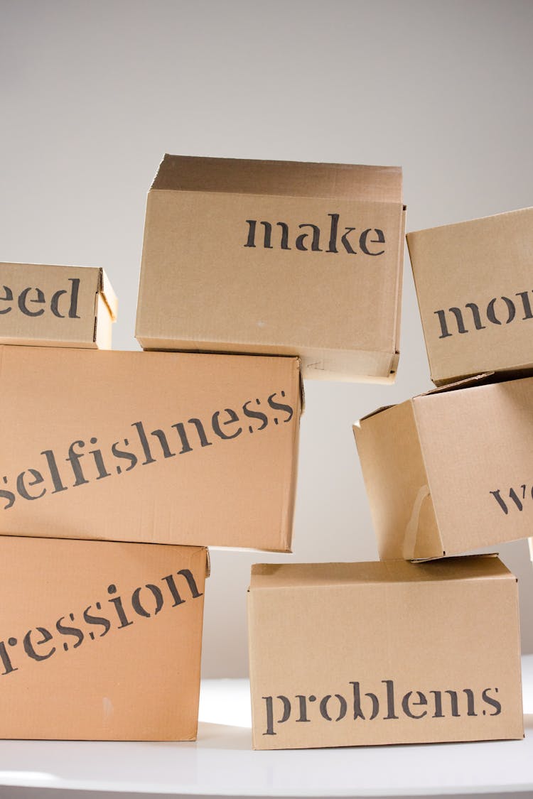 A Stack Of Cardboard Boxes With Words Written On Them 