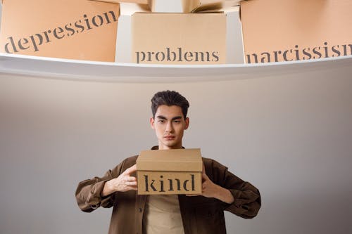 Free A Man Holding a Box with Kind Stock Photo