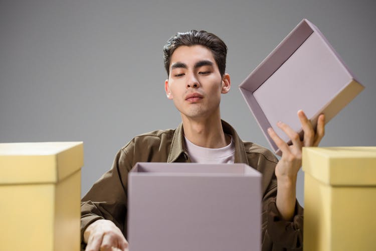 A Man Opening A Box